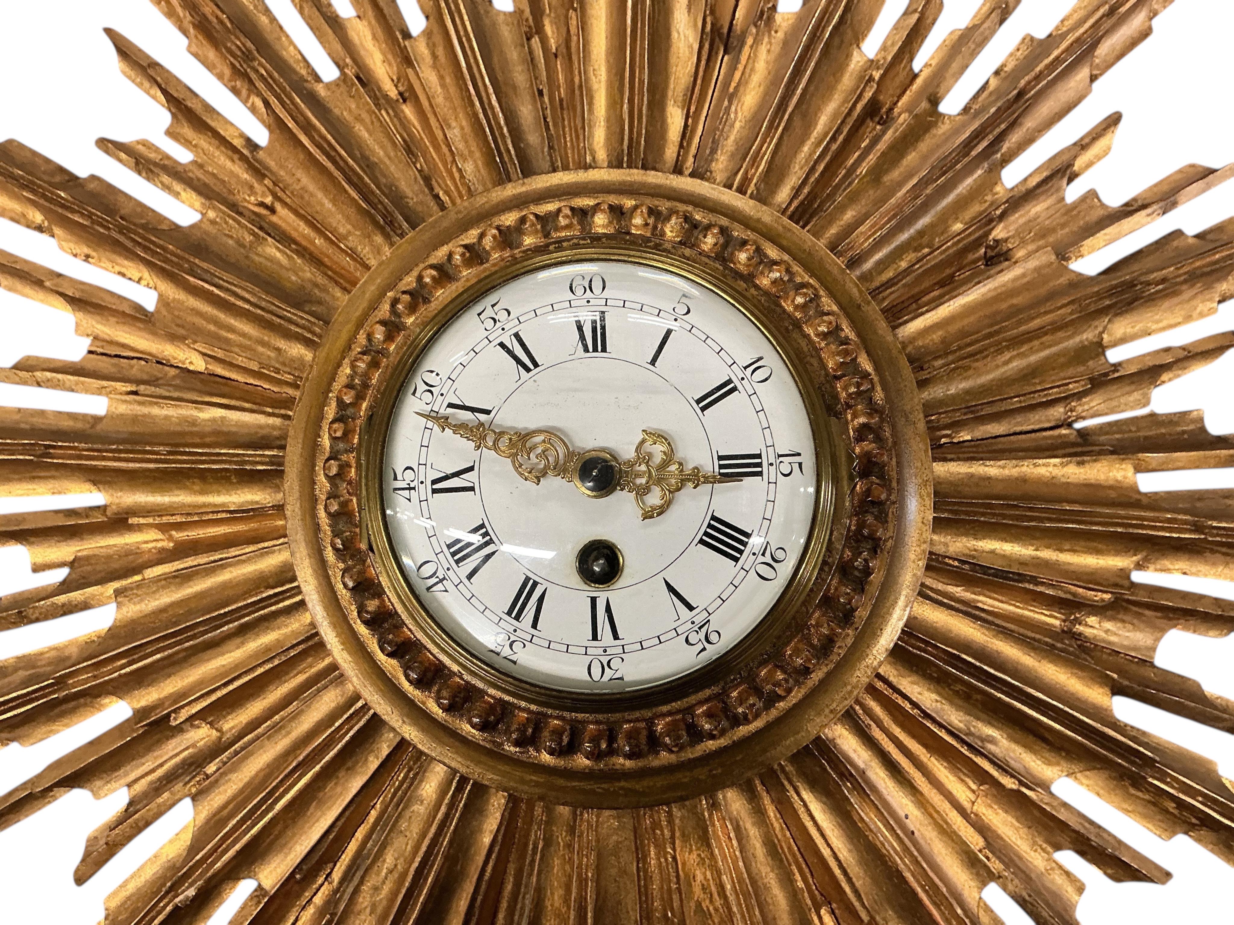An early 20th century carved giltwood starburst wall timepiece, diameter 62cm